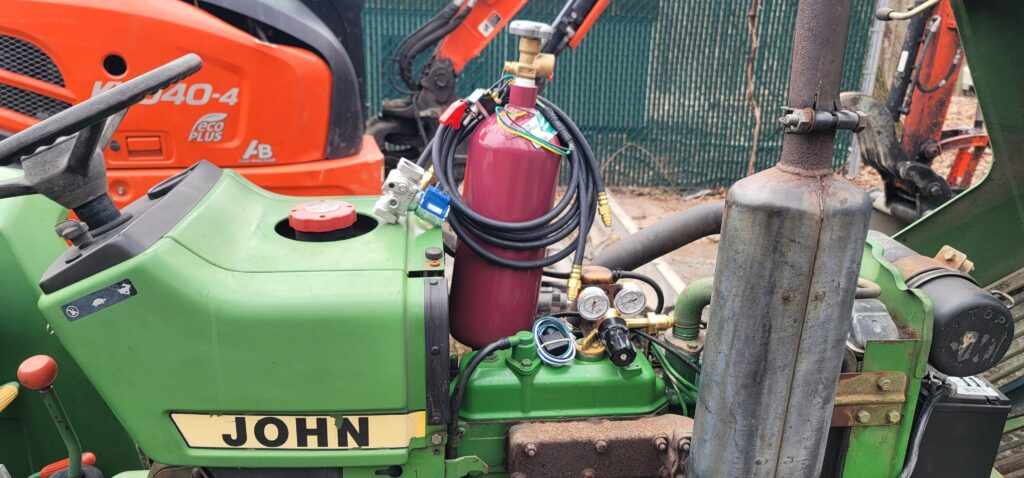 JTM RDS installed on John Deere tractor with Kubota excavator in background